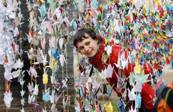 A woman looks at origami cranes in Valparaiso city